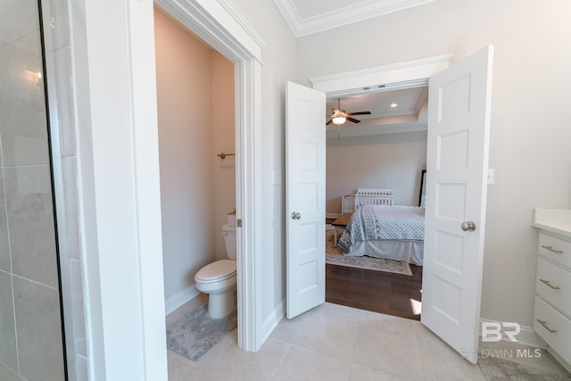 bathroom with ornamental molding, vanity, ceiling fan, tile patterned flooring, and toilet