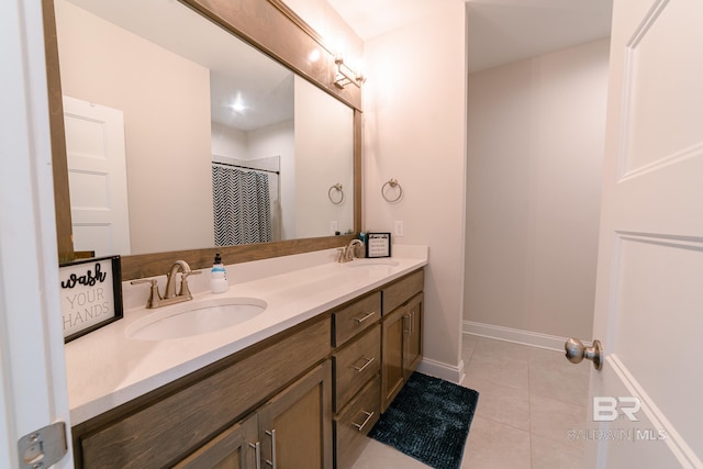 bathroom with tile patterned floors, vanity, and curtained shower