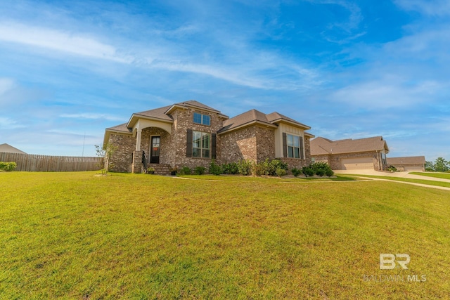 view of front of property featuring a front yard and a garage