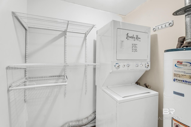 washroom with stacked washer / drying machine and gas water heater