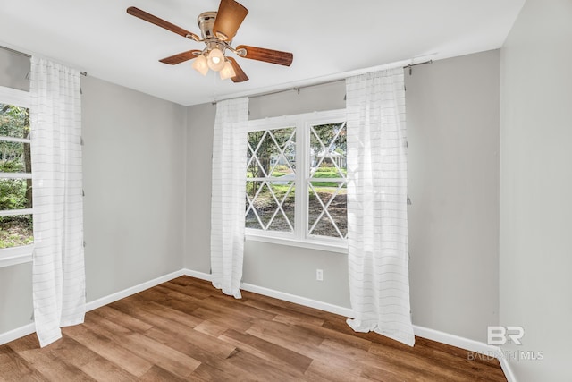 unfurnished room with hardwood / wood-style floors, ceiling fan, and a wealth of natural light