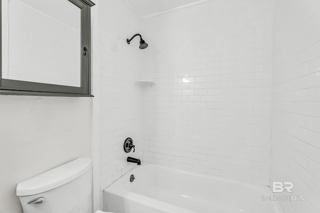 bathroom featuring tiled shower / bath combo and toilet