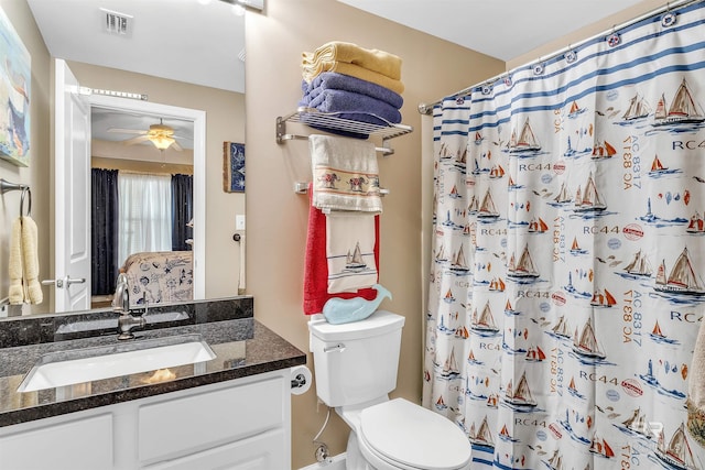 full bath featuring curtained shower, visible vents, toilet, vanity, and a ceiling fan