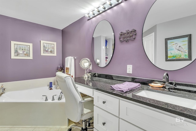 bathroom with a bath, tile patterned flooring, and vanity