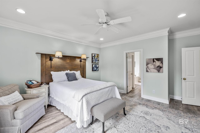 bedroom with hardwood / wood-style floors, ceiling fan, connected bathroom, and crown molding