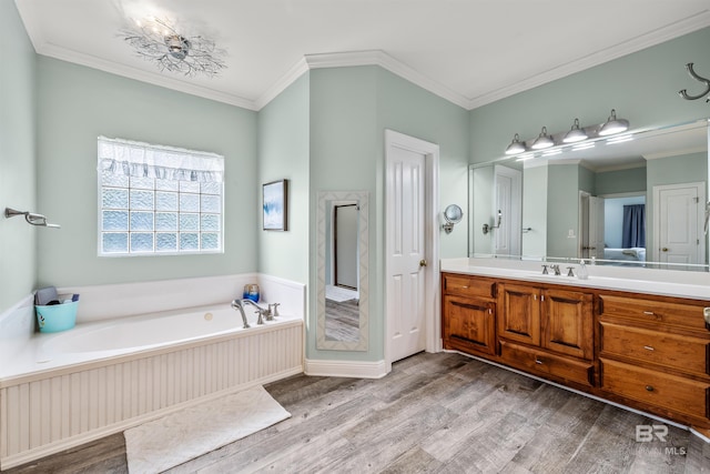 bathroom with crown molding, vanity, hardwood / wood-style flooring, and a tub