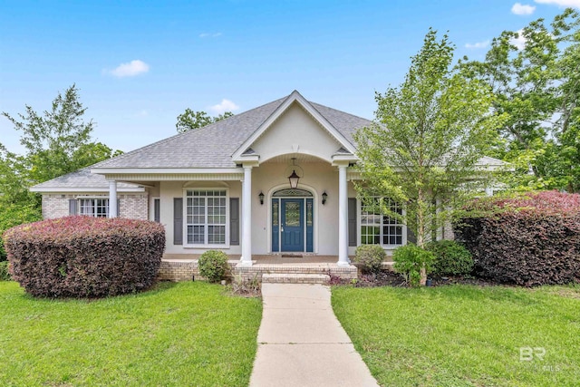 view of front of house with a porch and a front lawn