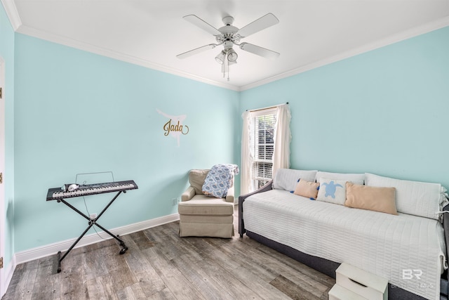 bedroom with ornamental molding, wood-type flooring, and ceiling fan