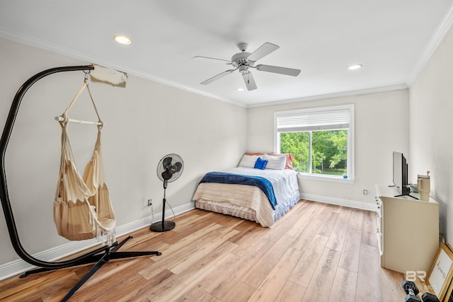 bedroom featuring light wood-type flooring, crown molding, and ceiling fan