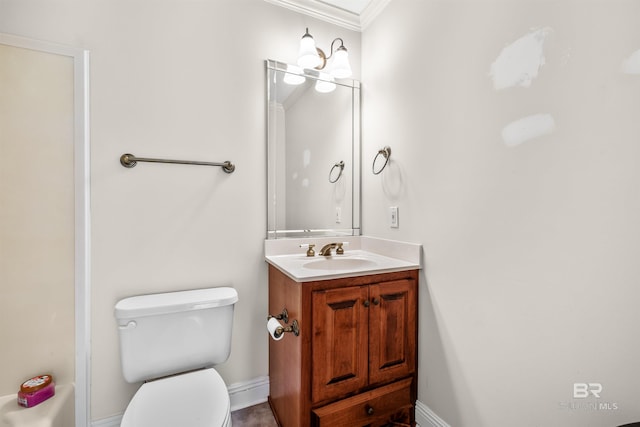 bathroom featuring toilet, crown molding, and vanity