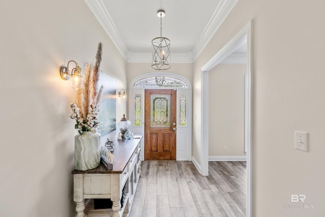 entryway featuring ornamental molding and light hardwood / wood-style floors