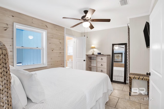 bedroom with wood walls, ceiling fan, light tile patterned floors, and ornamental molding