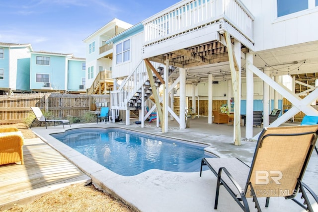 view of pool with a wooden deck and a patio