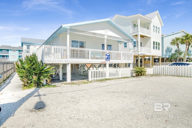 raised beach house featuring a carport