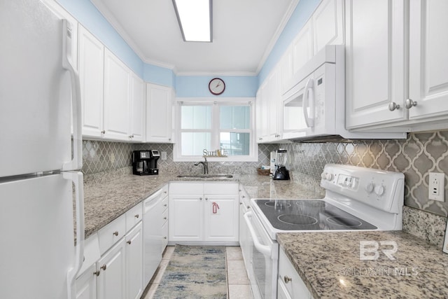 kitchen featuring white appliances, white cabinets, and sink