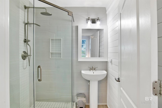 bathroom with walk in shower and tile walls