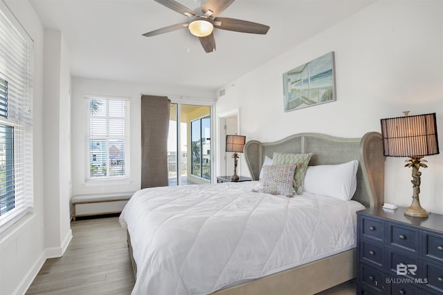453 Dune Dr Unit 101, Gulf Shores, AL 36542 - bedroom with baseboards, a ceiling fan, and wood finished floors