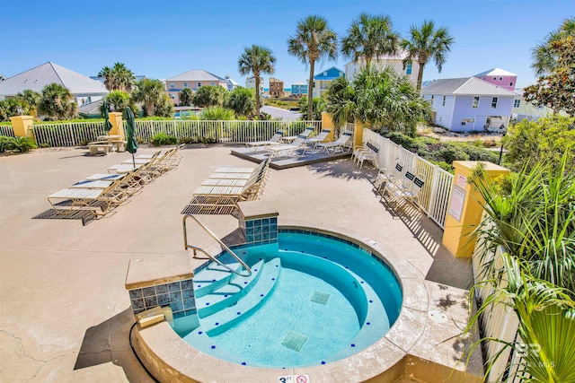 view of pool featuring a community hot tub and a patio area