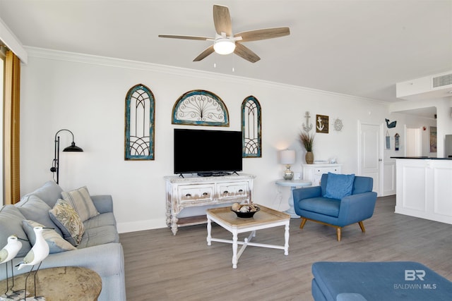 453 Dune Dr Unit 101, Gulf Shores, AL 36542 - living area featuring crown molding, baseboards, a ceiling fan, and wood finished floors