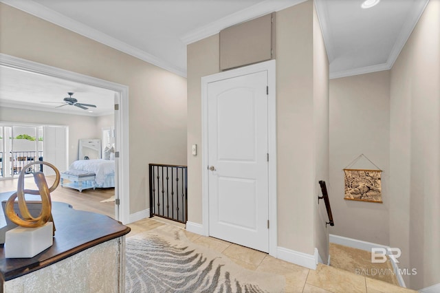 hallway featuring ornamental molding, baseboards, an upstairs landing, and light tile patterned floors