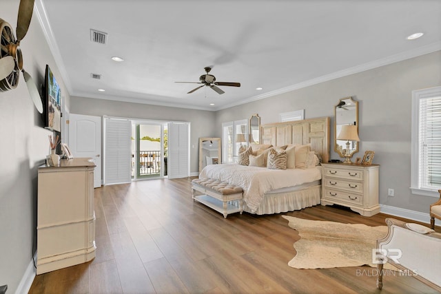 bedroom with baseboards, visible vents, dark wood-type flooring, access to exterior, and crown molding