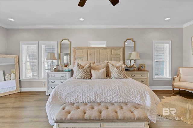 bedroom featuring multiple windows, wood finished floors, and baseboards