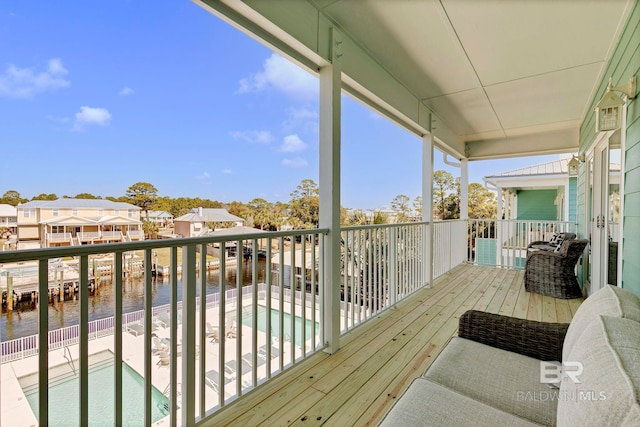 wooden deck featuring a water view and a residential view