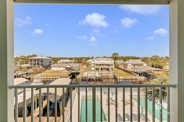 balcony featuring a water view and a residential view