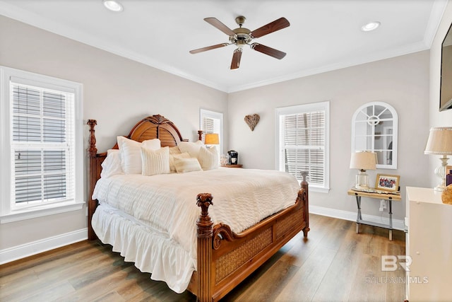 bedroom featuring ornamental molding, wood finished floors, and baseboards