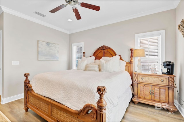 bedroom with visible vents, baseboards, a ceiling fan, light wood-style flooring, and ornamental molding