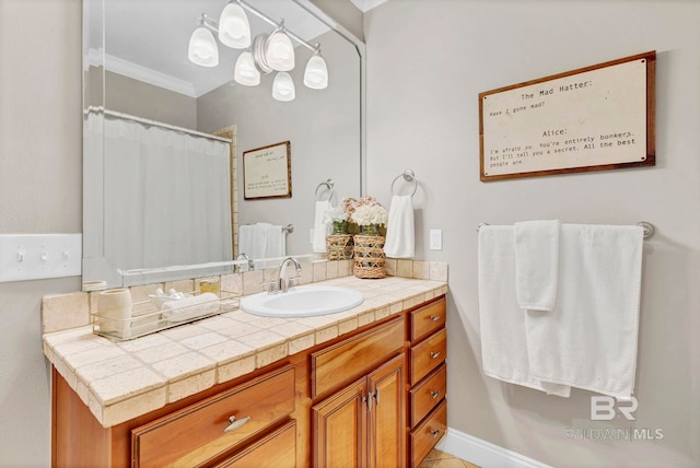 full bathroom with ornamental molding and vanity