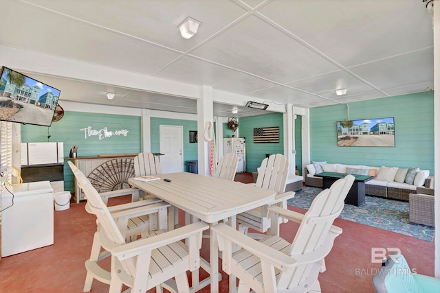 dining area featuring concrete flooring