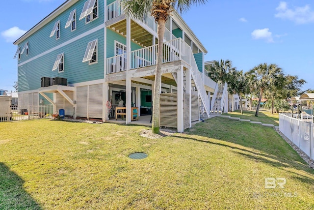 back of property featuring a patio area, stairs, central AC, and a lawn