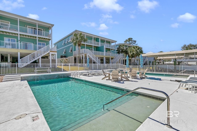 pool featuring a patio and fence