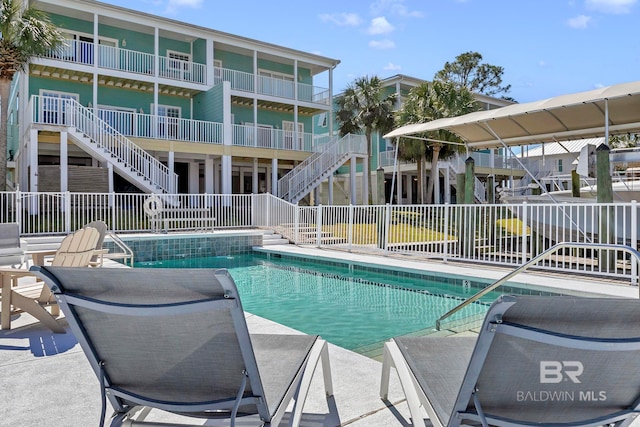 pool featuring stairs and fence