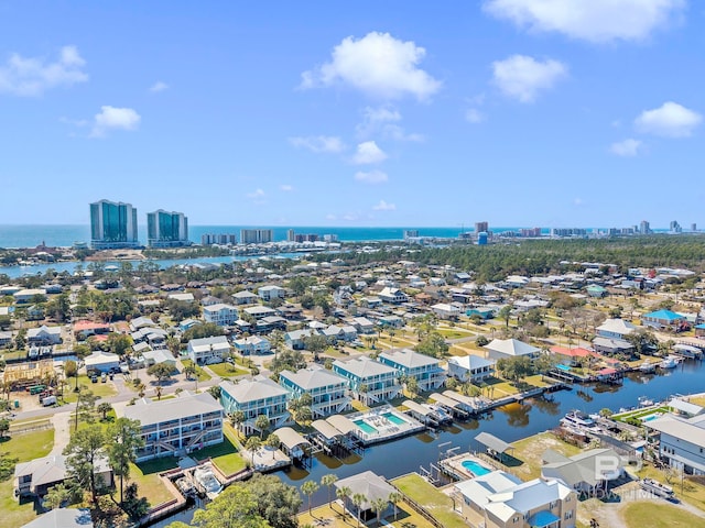 birds eye view of property with a water view and a city view