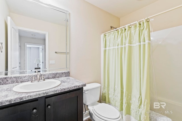 bathroom featuring toilet and vanity