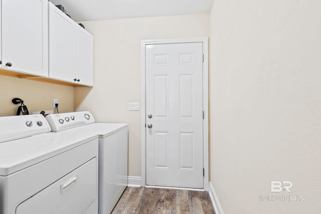 laundry area with hardwood / wood-style floors, cabinets, and independent washer and dryer