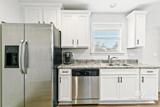 kitchen featuring light hardwood / wood-style floors, white cabinetry, sink, and appliances with stainless steel finishes