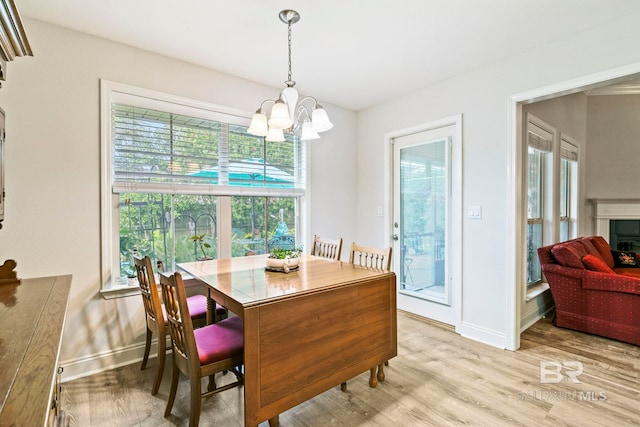 dining area featuring a wealth of natural light, light hardwood / wood-style flooring, and a notable chandelier