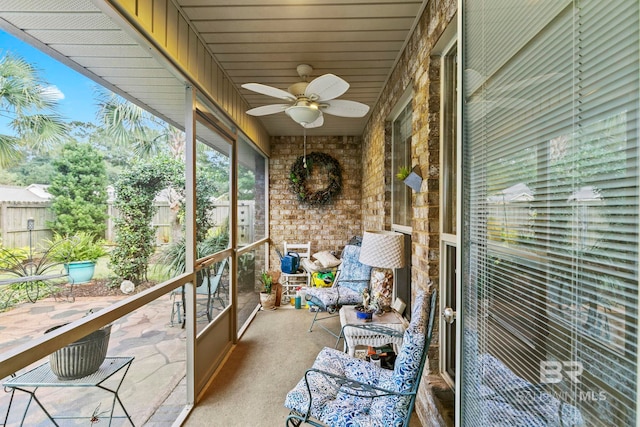 unfurnished sunroom with ceiling fan