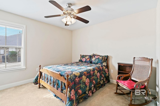 bedroom featuring light colored carpet and ceiling fan