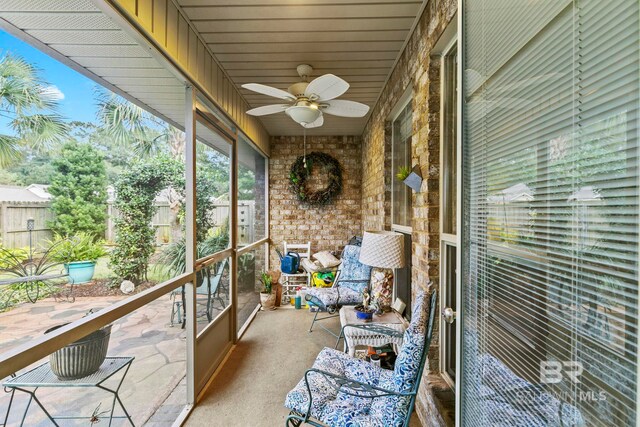 unfurnished sunroom featuring ceiling fan