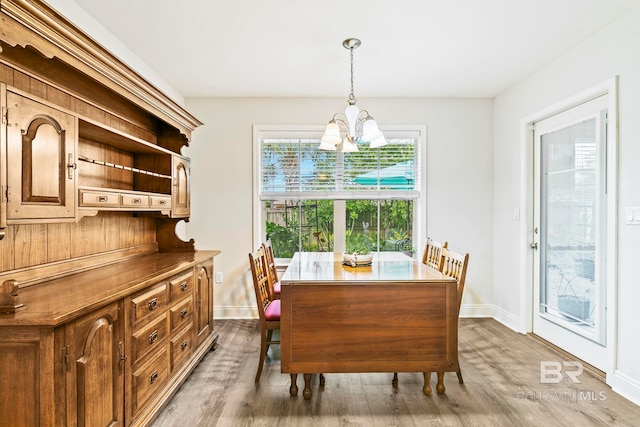 dining room with an inviting chandelier and hardwood / wood-style flooring