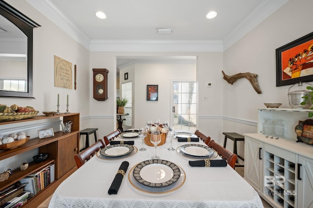 dining room featuring crown molding