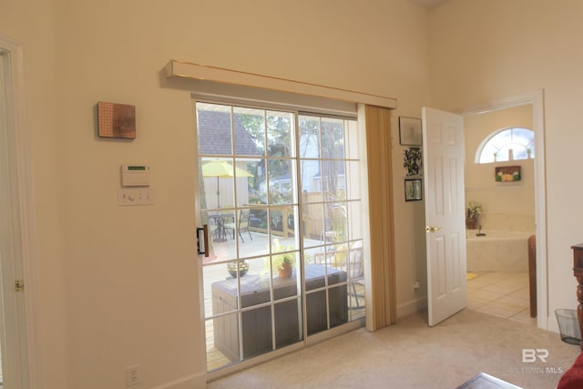 entryway with light carpet and a wealth of natural light