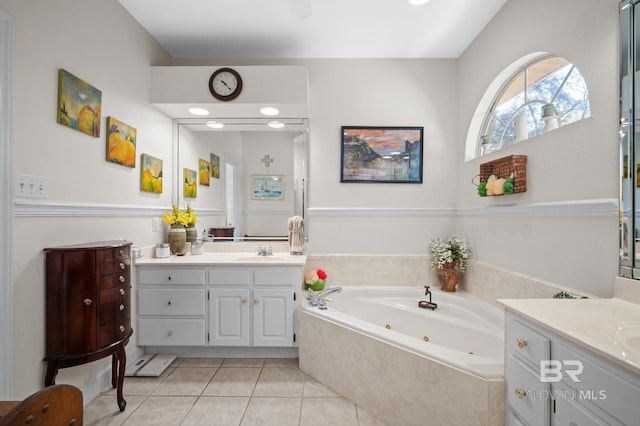 bathroom with vanity, tile patterned floors, and tiled bath