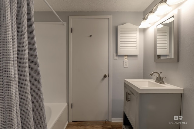 106 Golf Ter Unit 106, Daphne, AL 36526 - full bath featuring vanity, shower / bath combo with shower curtain, wood finished floors, and a textured ceiling