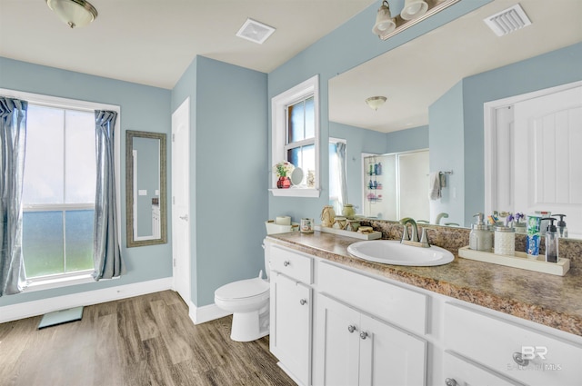 bathroom with hardwood / wood-style flooring, plenty of natural light, and an enclosed shower