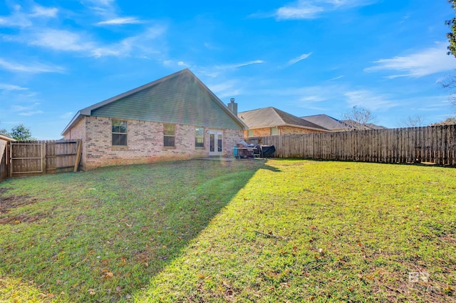 rear view of house featuring a yard